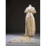 Beaded lace wedding dress and train designed by Aida Woolf, London, 1914. Worn by Phyllis Blaiberg for her marriage to Bertie Mayer Stone at the Bayswater Synagogue, London on 9 September 1914. Gift of Mrs B. Rackow
