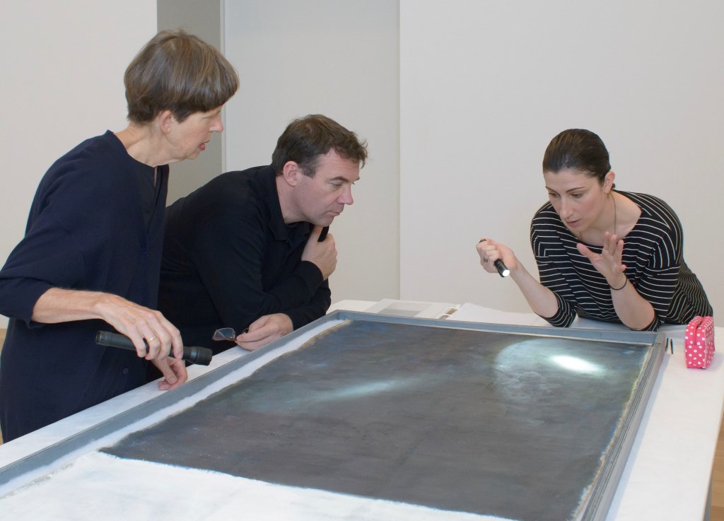 Sarah Hillary, Tom Learner and Tijana Cvetkovic discussing the painting's surface. Image courtesy of Auckland Art Gallery Toi o Tamaki