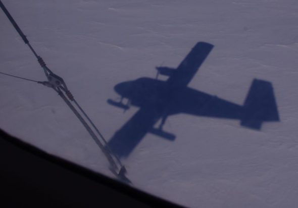 The shadow of a ski-equipped Twin Otter about to land at South Berkner fuel cache. Image: Colin Miskelly