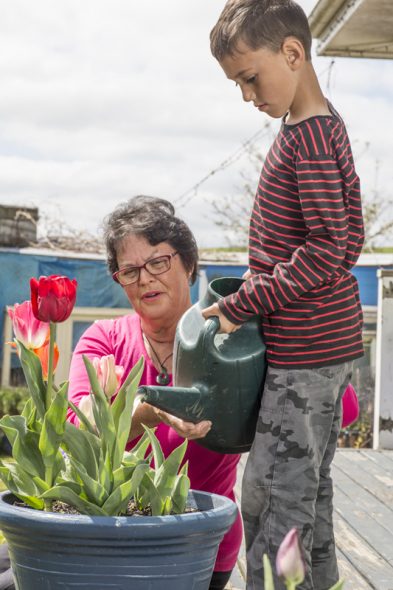 Mikaere Haumaha with his mum, and with Maama in the garden. Photo by Norm Heke, Te Papa, 2015