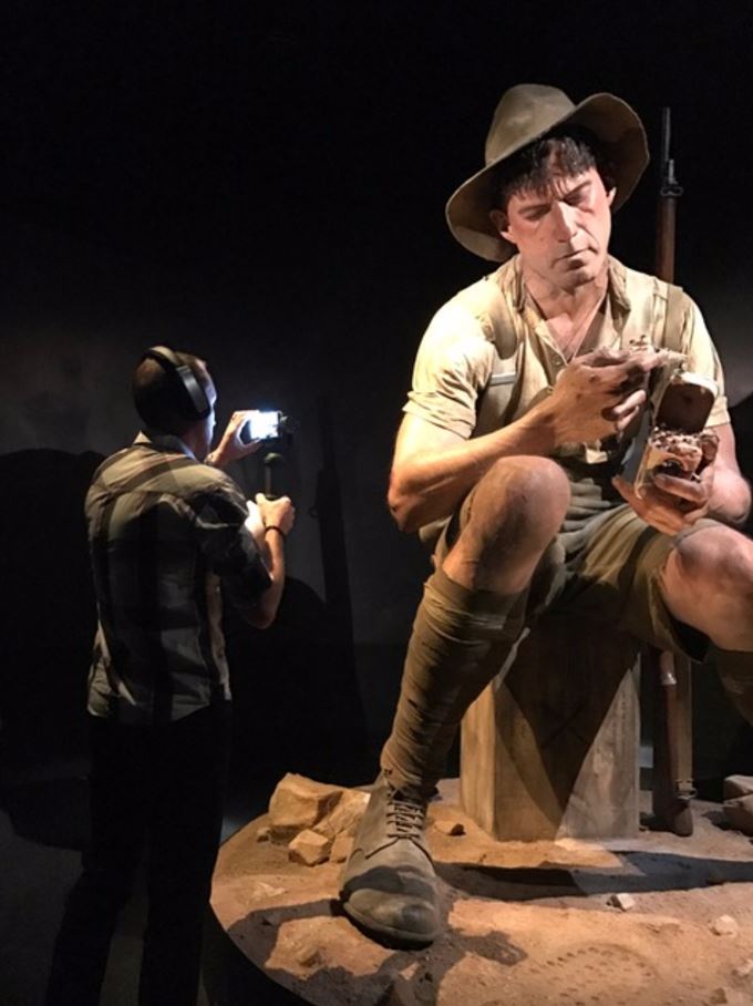 A man films one of the giant models in the Gallipoli exhibition