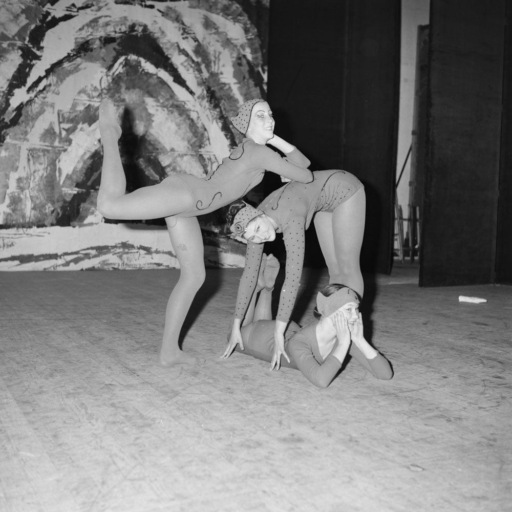 Black and white photo of three dancers in leotards on a stage