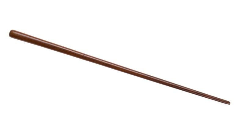 A long brown tapered wooden pole on a white background