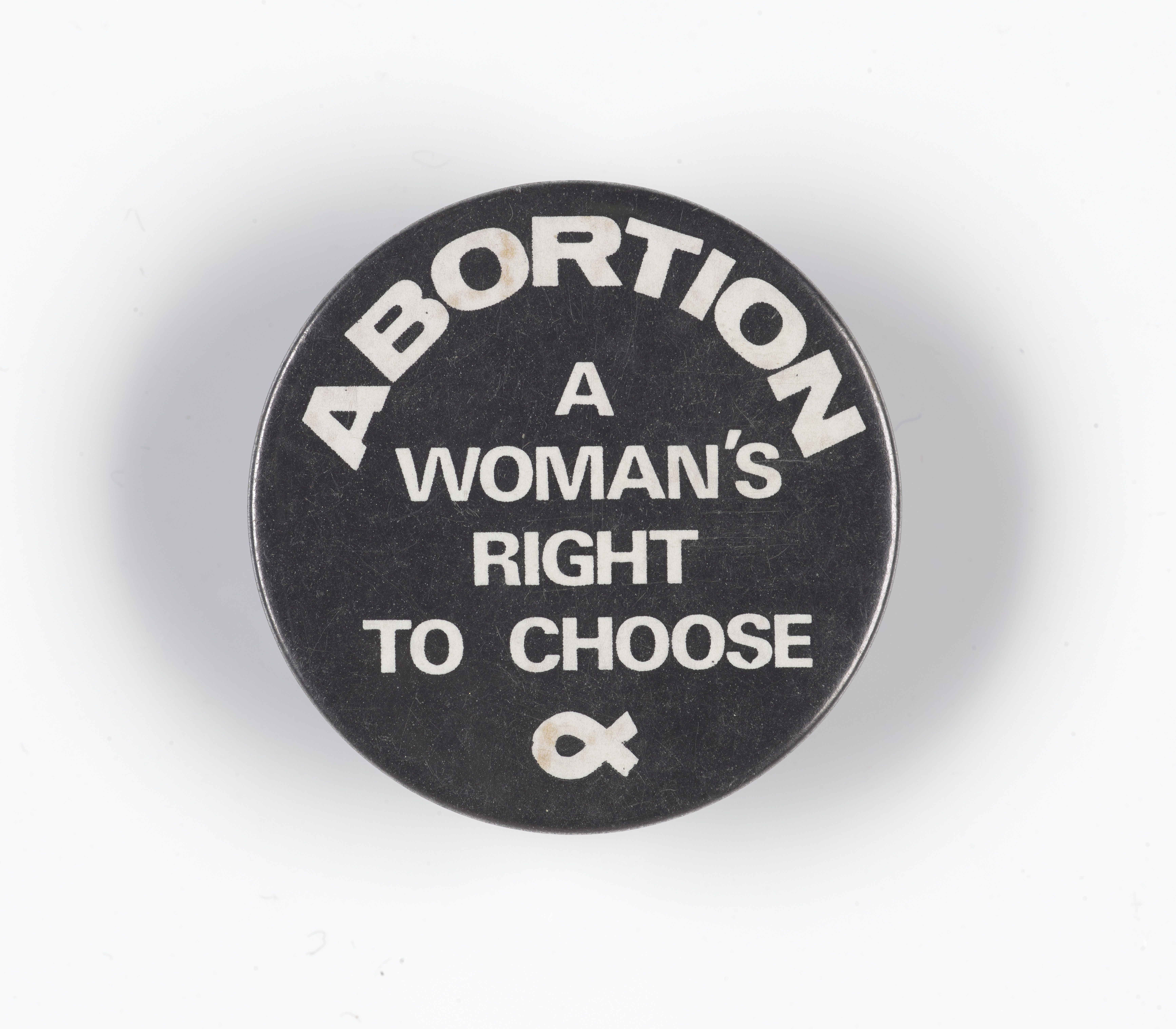 A badge with protest words on it Abortion a woman's right to choose