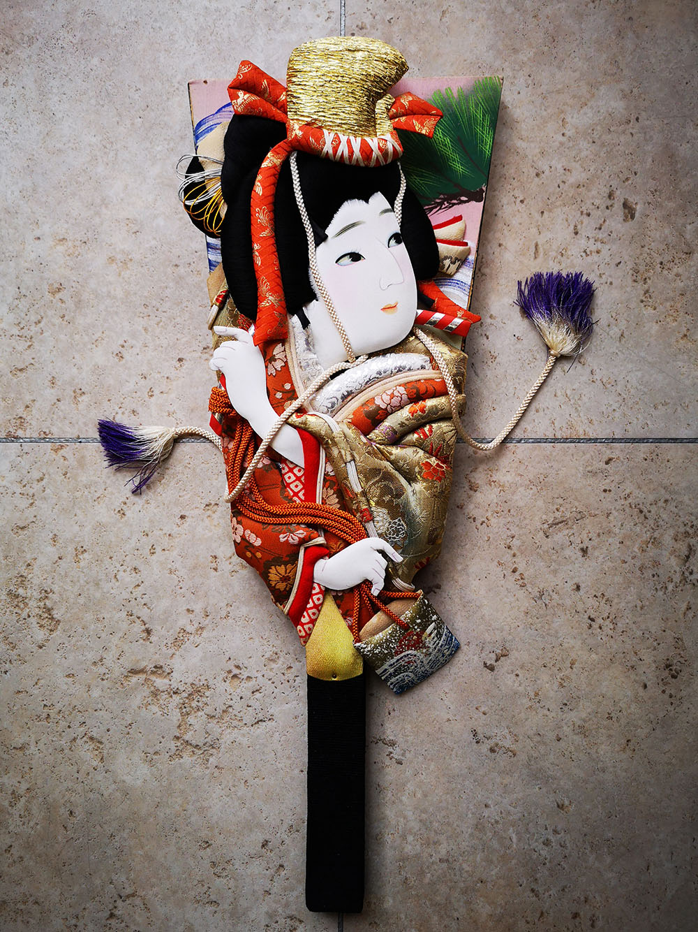 Paddle adorned with a three-dimensional picture of a lady wearing a kimono