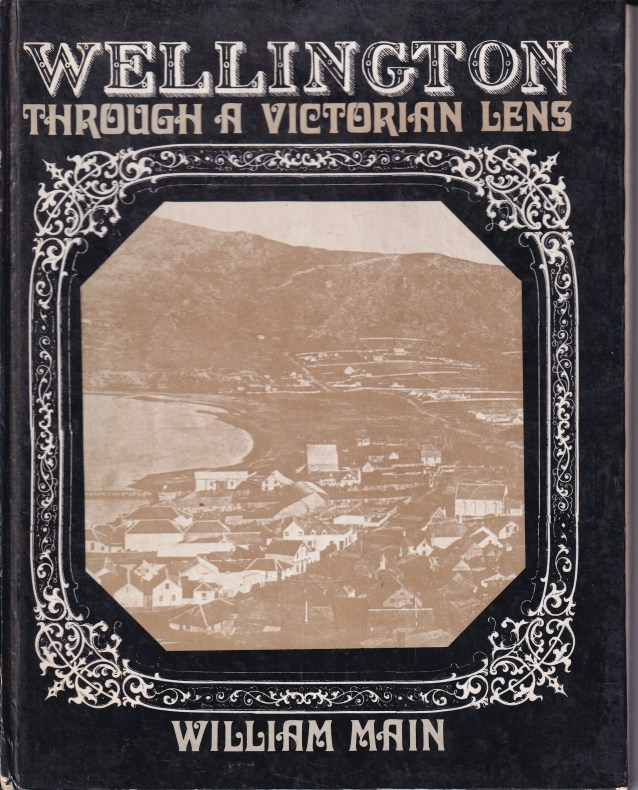 A book cover with the words 'Wellington through a Victorian lens', and 'William Main' in Victorian-style font. There is an image in the middle of the cover of a sepia-toned Wellington harbour.